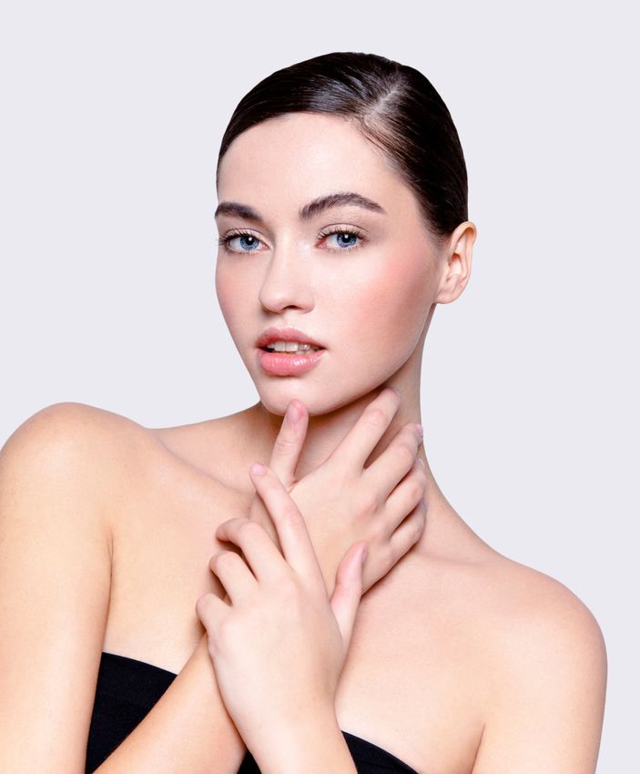 Crown Point Facial Treatment model with flawless skin wearing a stylish black dress